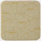 Square beige medical adhesive dressing with curved edges and printed pattern
