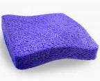 Purple textured medical-grade sponge on a white background