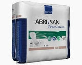 Pack of Abri-San Premium adult incontinence pads with green label and product details.