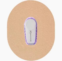 Dexcom G6 continuous glucose monitor with adhesive patch on skin-colored background