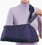 Person wearing an arm sling for injury support, medical supply for arm immobilization
