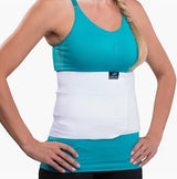 Woman wearing a white abdominal binder for medical support and post-surgery recovery.