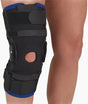 Person wearing an adjustable black knee brace for joint support and injury recovery