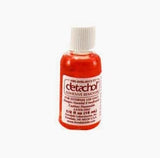 Red adhesive remover bottle with white cap for medical supply home delivery