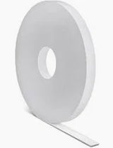 Large roll of white medical tape on a neutral background