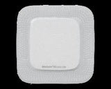 Square silicone foam medical wound dressing pad on black background