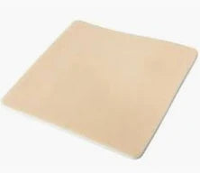 Beige medical foam dressing pad for wound care home use, square shape on white background
