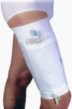 Leg wearing a white catheter leg bag holder with medical tubing, shown on bare thigh