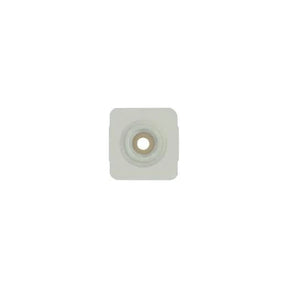 Square adhesive medical ostomy barrier with central opening on white background