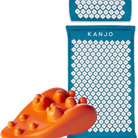 Blue acupressure mat and pillow with white spikes and orange massage tool for pain relief