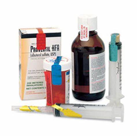 Medical supplies including inhaler box, prescription bottles, liquid medicine, and syringes.
