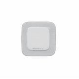Square sterile adhesive wound dressing with white border on plain background