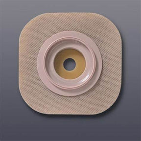 Square beige ostomy barrier for medical use on a gray background