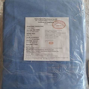 Packaged blue isolation gown with product certificate and compliance label for medical use