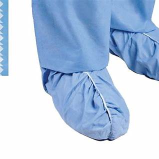 Disposable blue medical shoe covers over pants, protective hospital footwear