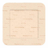Square beige medical wound dressing with adhesive border and printed label text.