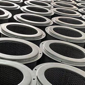 Close-up of multiple industrial air filters arranged in rows, metal rims and mesh visible