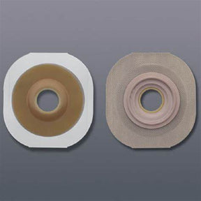 Two ostomy barrier baseplates with adhesive backing for medical stoma care on gray background