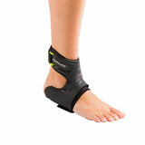 Foot wearing black ankle brace for injury support, orthopedic medical supply