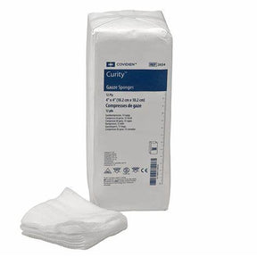 Pack of Curity gauze sponges with stacked white medical gauze pads in front