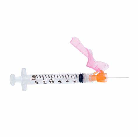 Sterile medical syringe with needle and pink safety cap for safe injections