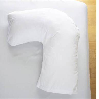 White L-shaped orthopedic pillow on a bed for medical support and comfort