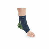 Person wearing a blue ankle support brace with green accents on a bare foot