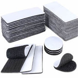 Stacked rectangular and round adhesive hook and loop fastener strips in black and white.