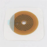 Adhesive ostomy barrier with cut-to-fit center for medical stoma care on white background