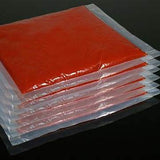 Stack of sealed red gel medical ice packs for pain relief or injury therapy