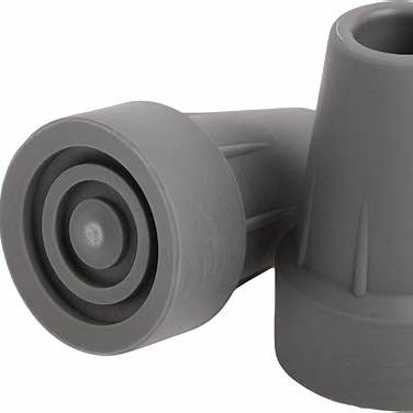 Close-up of two gray rubber cane tips for mobility aids on a white background