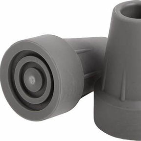 Close-up of two gray rubber cane tips for mobility aids on a white background
