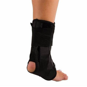Adjustable black ankle brace on foot for support and injury recovery