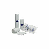 White medical gauze rolls and packaged sterile dressing on white background