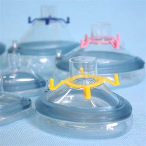 Assorted medical oxygen masks with colored valves on a blue background
