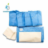 Blue disposable medical gowns and white absorbent pads on white background