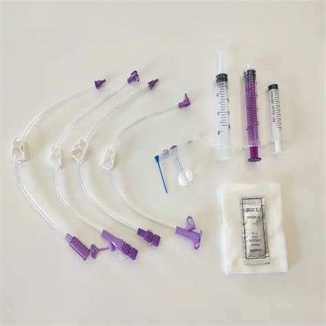 Medical supply kit with syringes, extension sets, filter, and sterile gauze on white background.