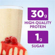 Protein shake with cherry cheesecake, 30g protein and 1g sugar highlighted on label.