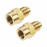 Pair of brass threaded adapters for medical equipment on white background