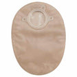 Beige ostomy pouch with circular flange for stoma, medical supply product on white background.