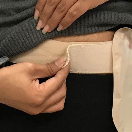 Hand adjusting ostomy belt with pouch for medical supplies under clothing
