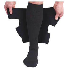Person applying black lower leg compression wrap over compression sock