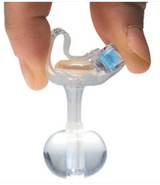 Hand holding a medical feeding tube device with clear balloon tip and blue safety cap