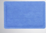 Blue disposable medical underpad on a light background