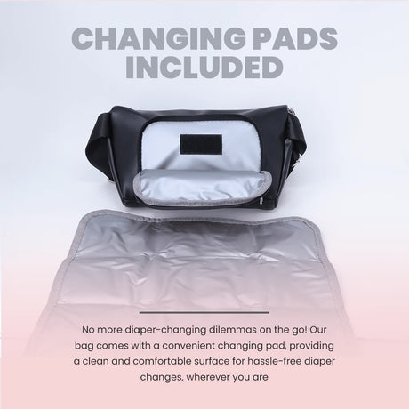 Black crossbody diaper bag with included portable changing pad, open on display.